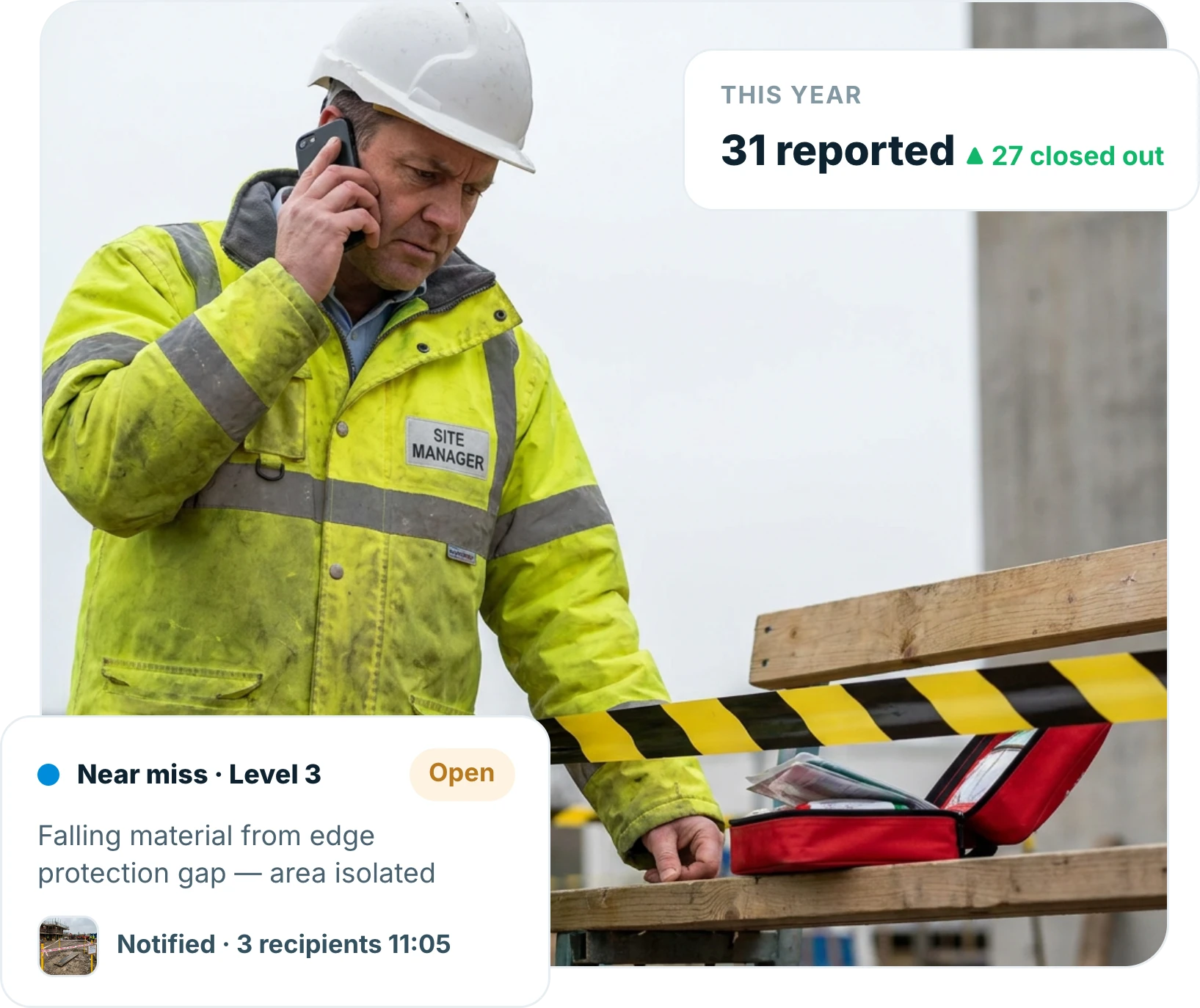 Site manager recording an incident report on a phone beside a taped-off area on a construction site