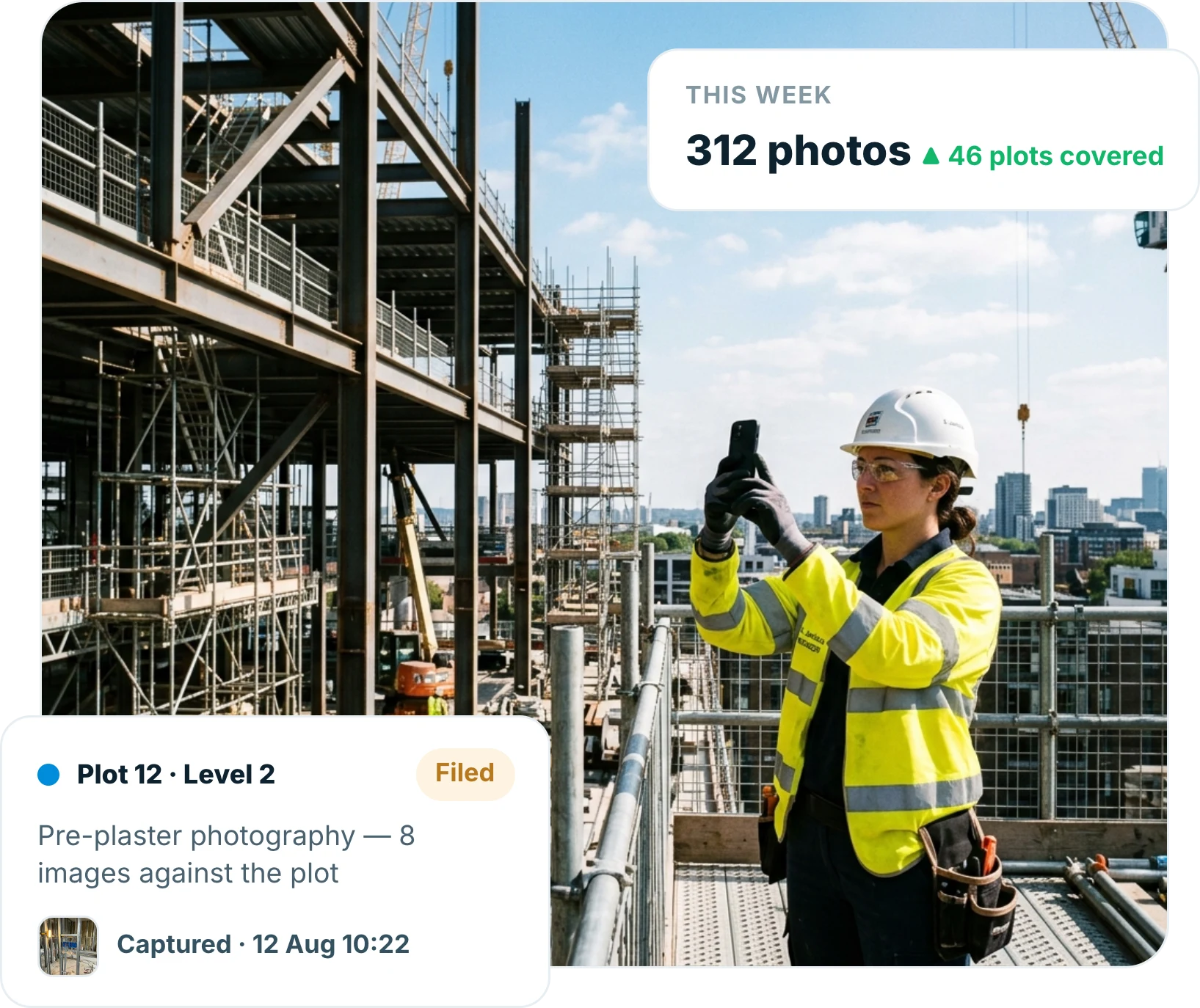 Site engineer photographing a partly built structure with a smartphone on a construction site