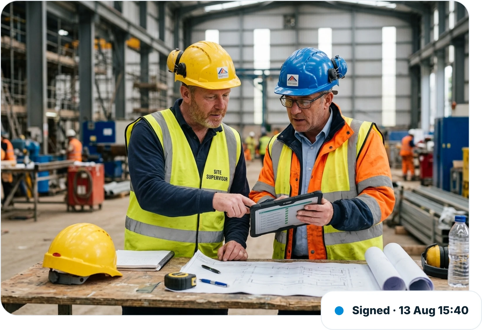 Two site supervisors reviewing a QA checklist on a tablet on site, with the inspection signed off at 15:40