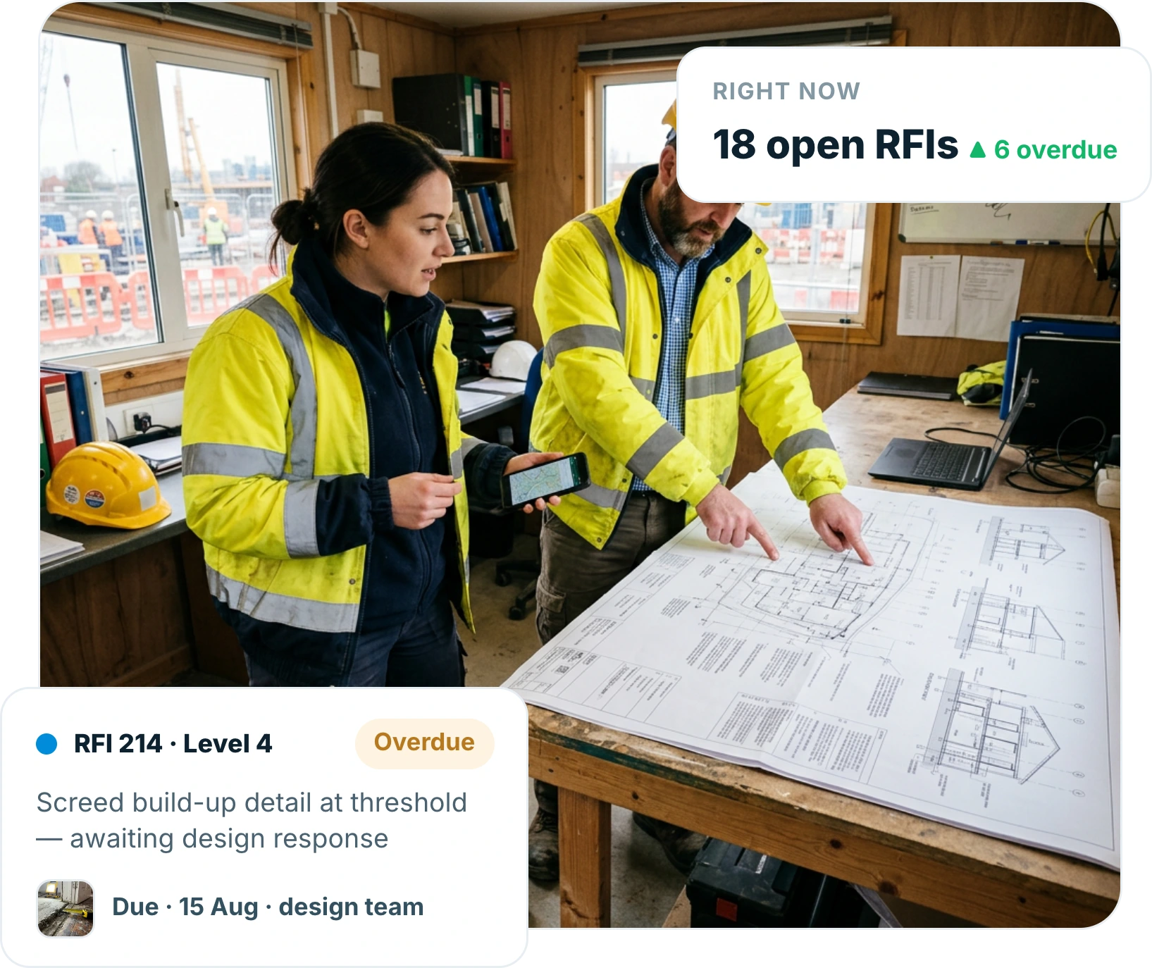 Site manager and engineer in a site cabin pointing at a technical drawing while holding a phone showing the same detail