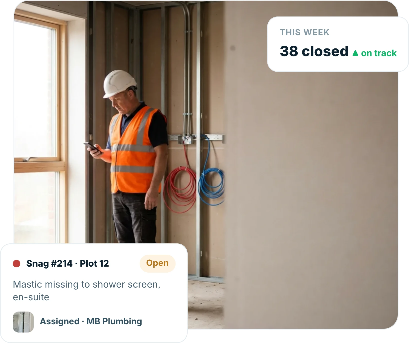 Site manager checking a snag on a phone in an unfinished plot, with an open snag for missing mastic assigned to a subcontractor