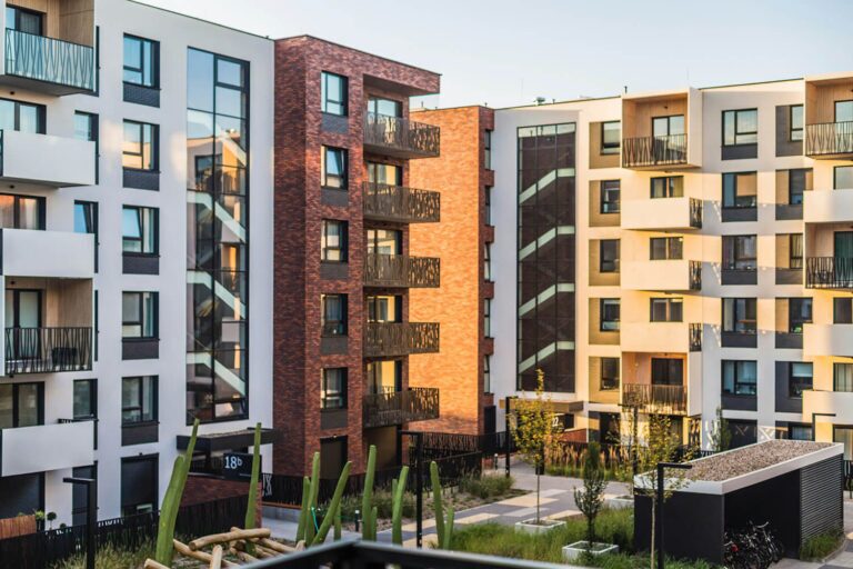 Modern residential apartment blocks with brick and render facades, the kind of development where NCD Group installs electrical and smoke ventilation systems